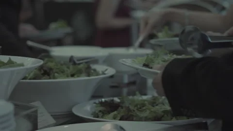 Guests serving salad at buffet table during event 스톡 동영상 236952674