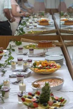Guests serving themselves from an elegant dessert buffet table Stock Photos