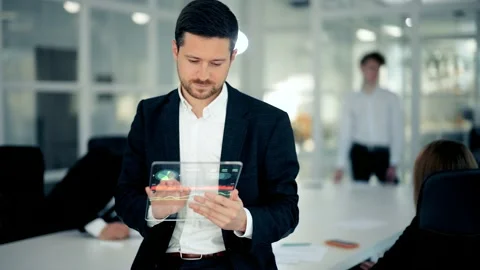 GUI (Graphical User Interface) concept. Сheerful male boss uses a holographic Stock Footage 143322757