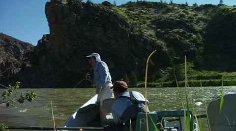 Guide and Angler Pull Anchor and float down towards Canyon Stock Footage 14820363