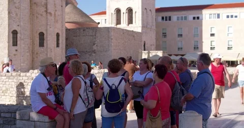 Guide explaining a group of tourists inner city Zadar, tourism Croatia 4K Stock Footage 79217319