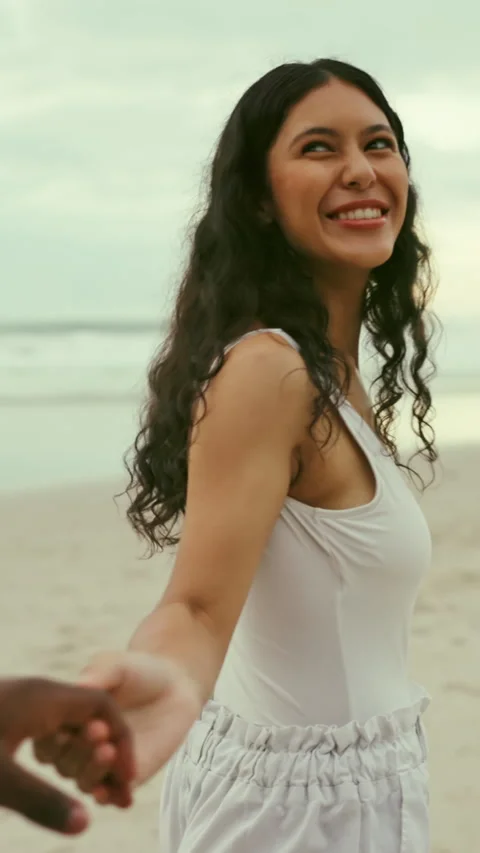 Guide, holding hands and laughing with woman on beach for holiday, travel or Stock Footage 340387323
