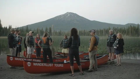 Guide instructing tourist about sailing in canoe Stock Footage 87613255