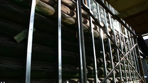 Guide metal strips on an old log wall, preparation for facing the house, renovat Stock Footage 148010980