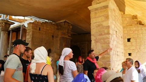 The guide provides historical information to a group of tourists before visiting Stock Footage 117933746