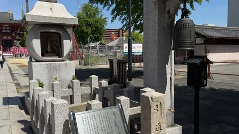 Guide Stone Prince Shotoku Guide Bell near stone torii gate at Shitennō-ji in Видео 347981203