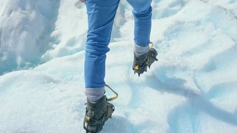 Guide Walking through glacier tunnel with guide using ice pick. Stock Footage 79429496