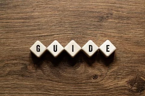 Guide - word concept on building blocks, text Stock Photos