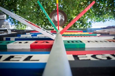 Guidepost with multiple destination countries of the world on arrows sticks i Stock Photos