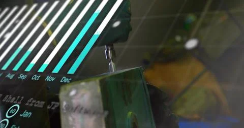 Guiding gloved hand steering drill bit into workpiece in workshop vise, with bar Stock Photos