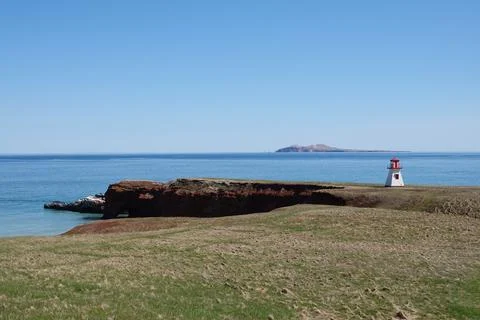 Guiding Light: A Serene Lighthouse View in Les Îles-de-la-Madeleine Stock Photos