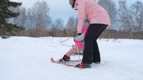 Guiding a young skier on her first ski experience Stock Footage 297091315