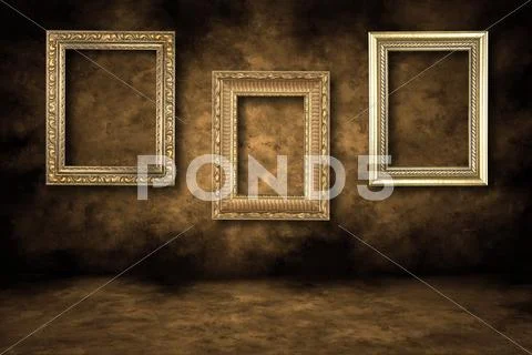 Guilded empty picture frames hanging Stock Photos