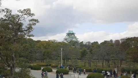 Guilded tour group walking through Osaka castle Japan  스톡 동영상 72577505