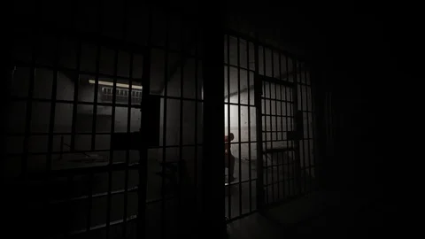 Guilty prisoner sitting in old, dark prison cell. Stock Footage 88279391