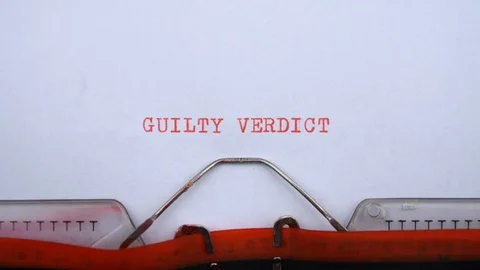 Guilty verdict - phrase printed on an old typewriter in red letters, close up. Stock Footage 128400255