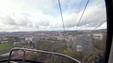 Guimaraes Cityscape from Cable Car on Cloudy Day with Lush Green Hills Stock Footage 321893549