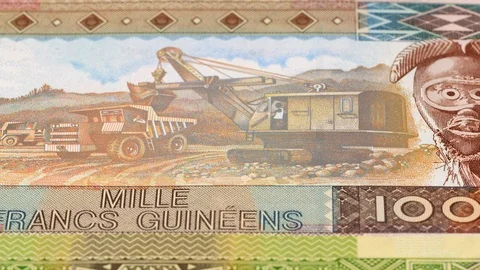 Guinea franc banknotes fast tracking. Guinean money. Slider shot, low angle. 4K Stock Footage 126008154