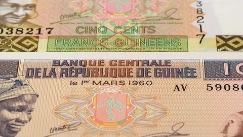 Guinea franc notes slow tracking. Guinean currency. Slider shot, low angle. 4K Stock Footage 126007728
