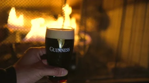 Guinness by fireplace Stock Footage 165831240