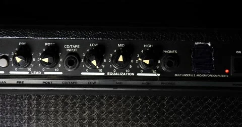 Guitar amplifier turn on man plugging wire into amp ready to rock Video stock 204901086