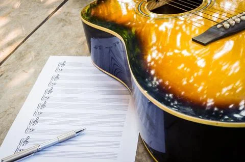 Guitar and blank notebook. Stock Photos