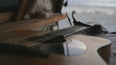 Guitar on Bed by The Ocean Stock Footage 87715200