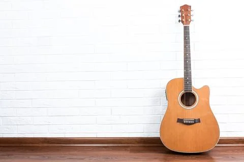 Guitar on a brick wall background Stock Photos