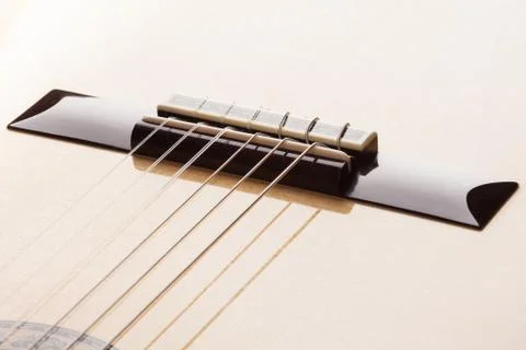 Guitar bridge on the varnished surface of a classical guitar. Stock Photos