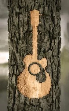 Guitar carved into the bark of a tree Stock Illustration