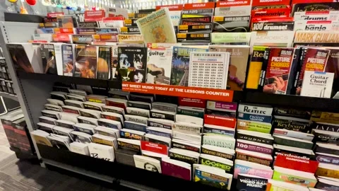 Guitar Center retail store interior guitar and piano learning books Stock Footage 170341542