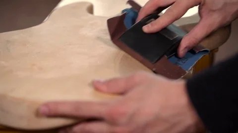 Guitar Craft. Hands of Guitar Maker Smooth Wooden an Electric Guitar Body Video stock 73968689