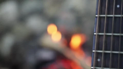 Guitar fingerboard in the background of a campfire Stock Footage 277567657