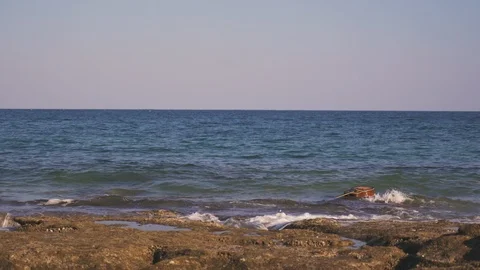 Guitar is floating, drifting on waves in sea or ocean. Western guitar swims Stock Footage 126951231