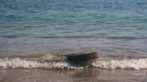 Guitar is floating, drifting on waves in sea or ocean. Western guitar swims Stock Footage 126971465