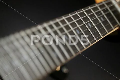 Guitar fret board on black background Stock Photos