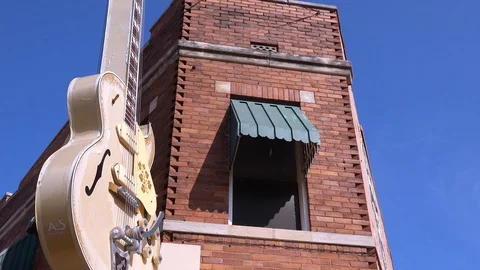 A guitar hangs outside a brick building Sun Studios music studio in Memphis Stock Footage 117798182