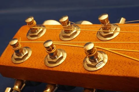 Guitar head with six strings and tuning knobs macro close up Stock Photos