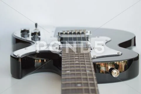 Guitar Laying on White Background Stock Photos