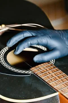 Guitar Luthier Plucking and Testing Single New String on Acoustic Guitar Body Stock Photos