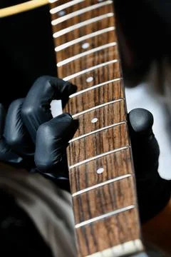 Guitar Luthier Testing Newly Installed String on Rosewood Fretboard Close Up Stock Photos