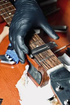 Guitar Luthier Testing Newly Installed String on Rosewood Fretboard Close Up Stock Photos