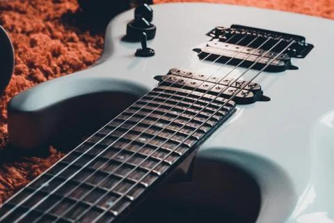 A guitar lying on a carpet. 写真素材