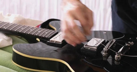 Guitar maintenance, mounting steel strings Stock Footage 105436620