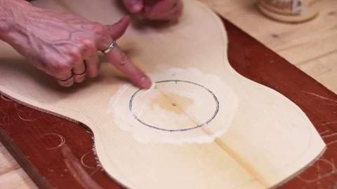 Guitar maker glues the rosette into the guitar body Stock Footage 112004894