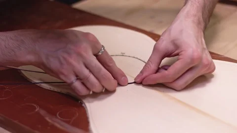 Guitar maker insert the rosette into the guitar body Stock Footage 112004057