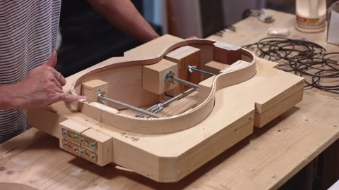 Guitar maker making a guitar from scratch Stock Footage 117980529