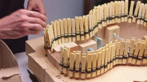 Guitar maker puts lining on half of hand-made acoustic guitar Stock Footage 117970922