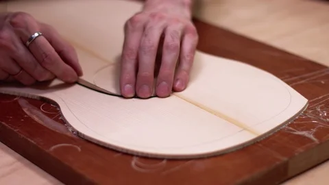Guitar maker puts rosette decoration on acoustic guitar Stock Footage 112003866