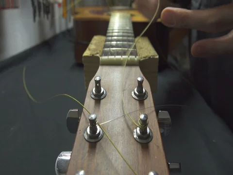 Guitar Maker Removing Old Guitar String Stockbeeldmateriaal 72595756